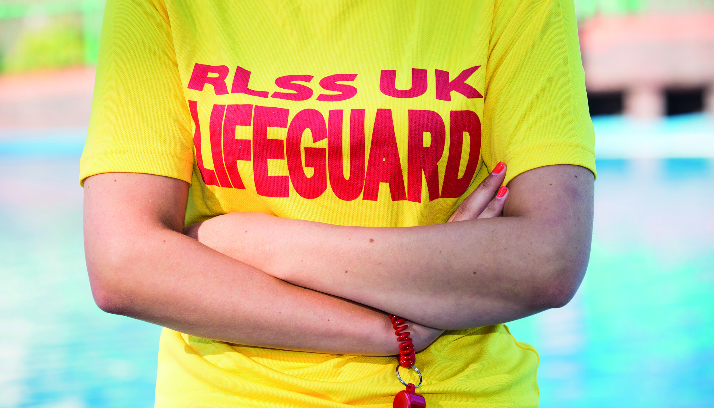 a person wearing a RLSS UK Lifeguard T-shirt
